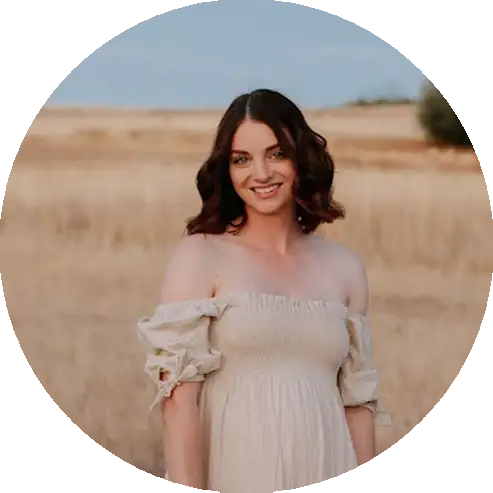 Courtney Reed from Capturing Candid Photography standing in a field at sunset in the Barossa region.